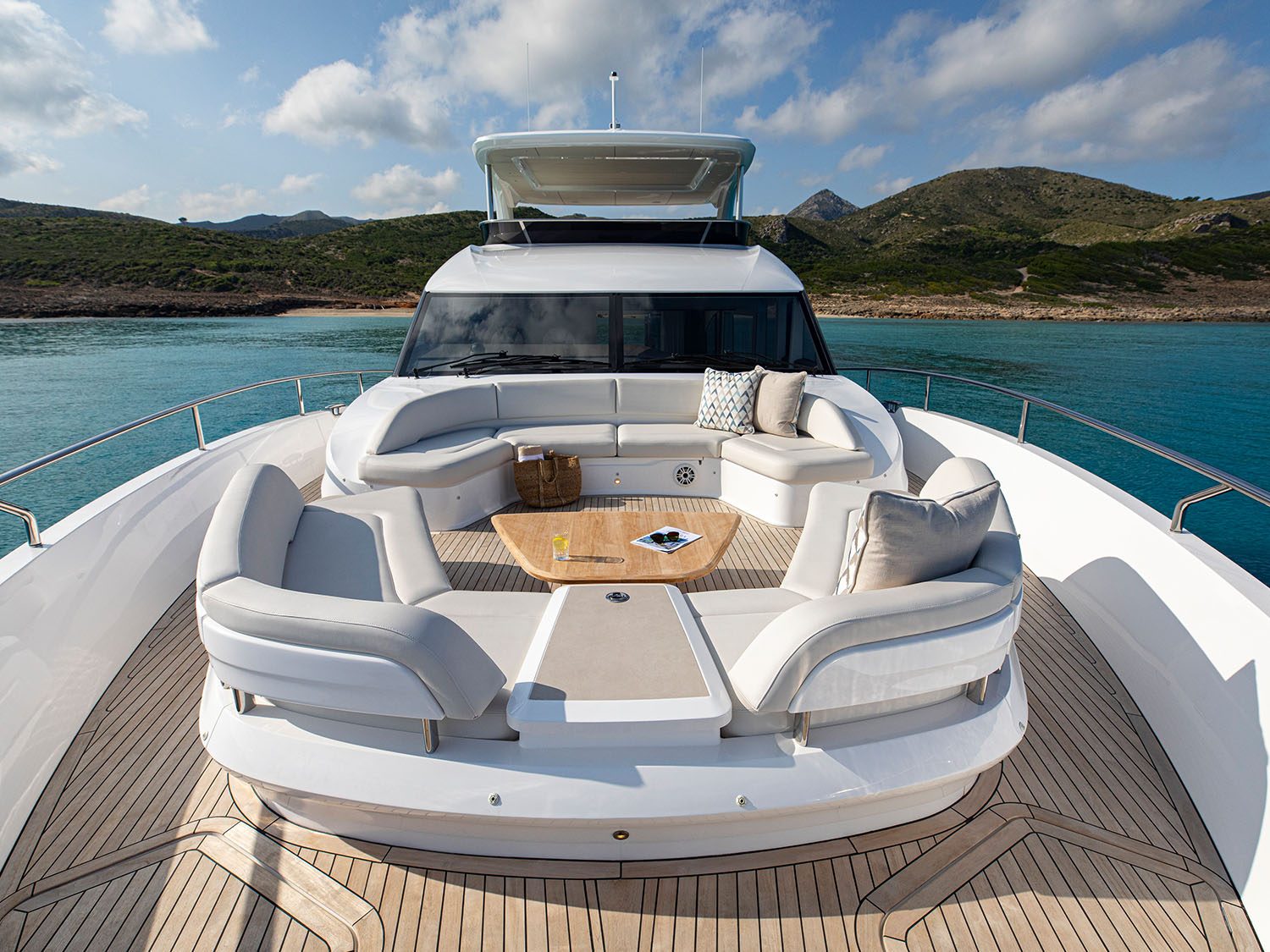 LUMI, a white Princess flybridge yacht, in profile on clear water